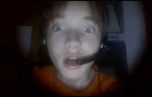 a young boy wearing headphones and a microphone .