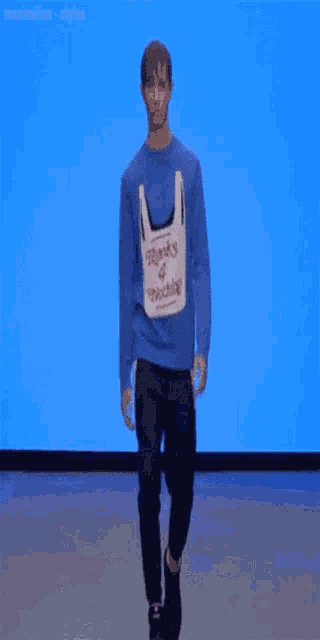 a man wearing a blue sweater that says thanks 4 nothing on it