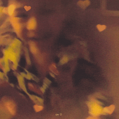 a blurry picture of a person with hearts and the word ch on the bottom