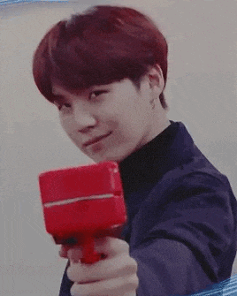 a close up of a person holding a red object .