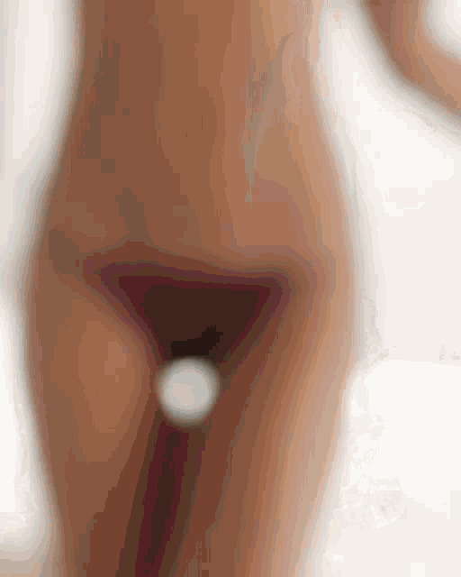 a blurred image of a woman 's bottom with a white spot in the middle
