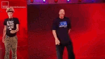 a blurry picture of a man in a black shirt standing in a ring .