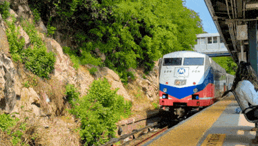 a red white and blue train with the number 206 on the front of it