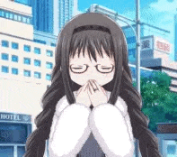 a girl with long hair is covering her mouth with her hands .