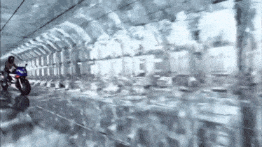 a person riding a motorcycle in a tunnel