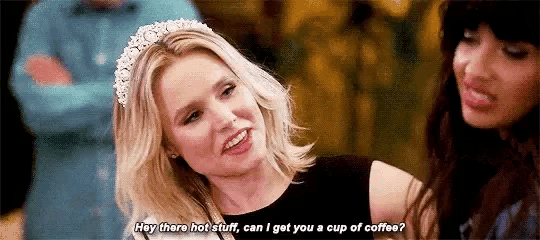 a woman wearing a tiara is talking to another woman while sitting next to her .