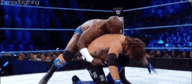 two men are wrestling in a wrestling ring with the words the next big thing written on the bottom