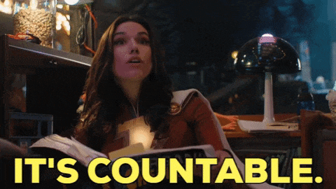 a woman reading a book with the words it 's countable on the bottom