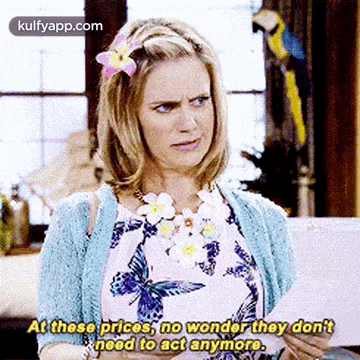a woman with a flower in her hair says at these prices