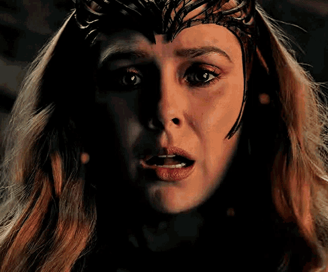 a close up of a woman 's face wearing a crown