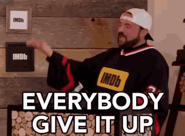 a man wearing a imdb jersey says everybody give it up