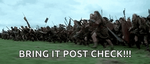 a large group of soldiers are running through a grassy field .