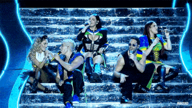 a group of people singing on a stage with a watermark that says rb030