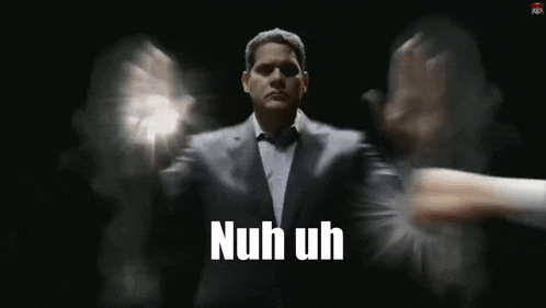 a man in a suit and tie says nuh uh in front of a black background