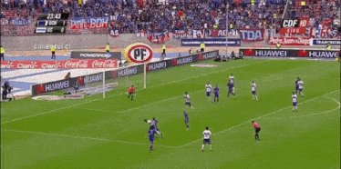 a soccer game is being played in a stadium with advertisements for huawei and coca cola