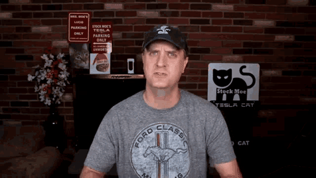 a man wearing a ford classic mustang shirt