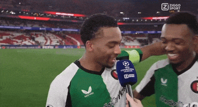 two soccer players are being interviewed by a person with a ziggo sport logo on the screen behind them