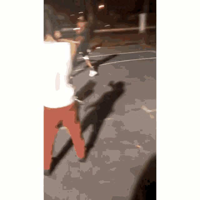 a blurry photo of people playing basketball on a court