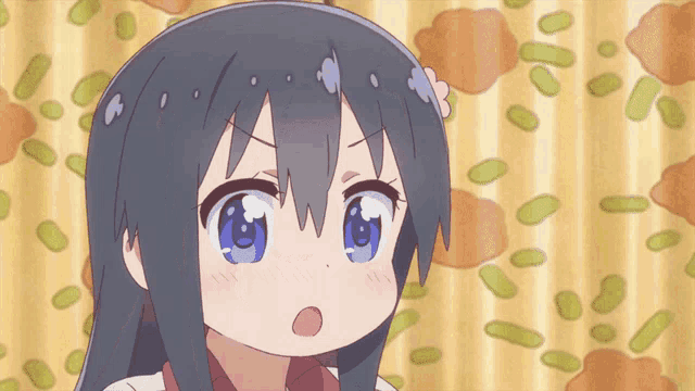 a girl with a surprised look on her face is standing in front of a curtain with green beans on it