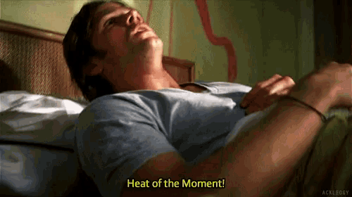 a man laying on a bed with the words heat of the moment written on the bottom