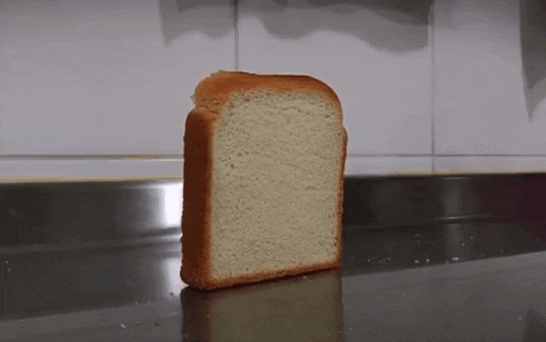 a loaf of bread is sitting on a stainless steel counter top