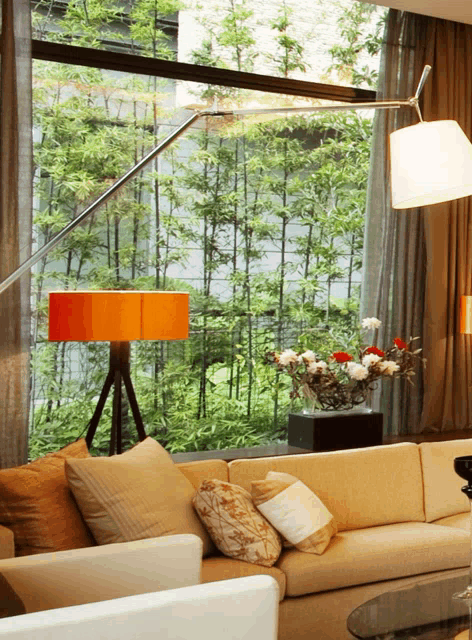 a living room with a couch and a lamp looking out a window