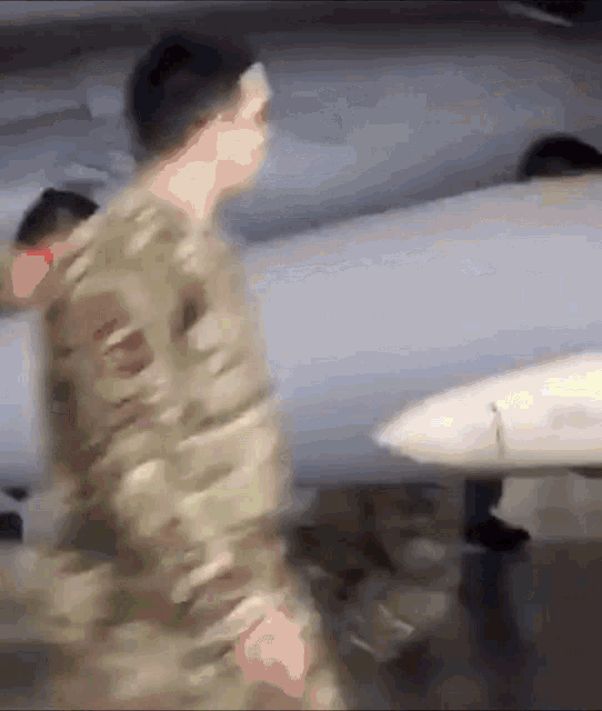a blurry picture of a man in a camouflage uniform