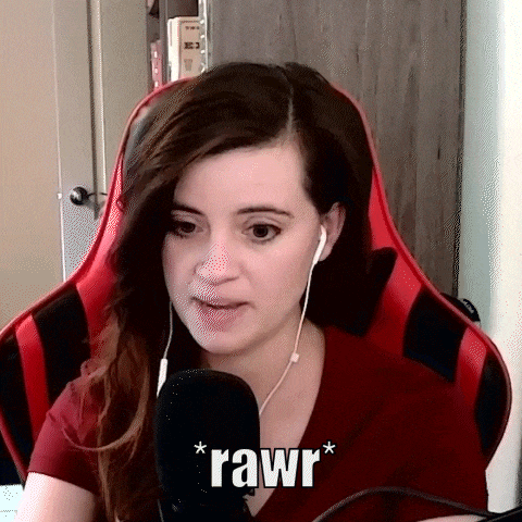 a woman is sitting in a red chair talking into a microphone .