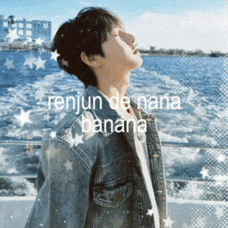 a man in a denim jacket stands in front of a body of water with the words " renjun de nana banana " written on it