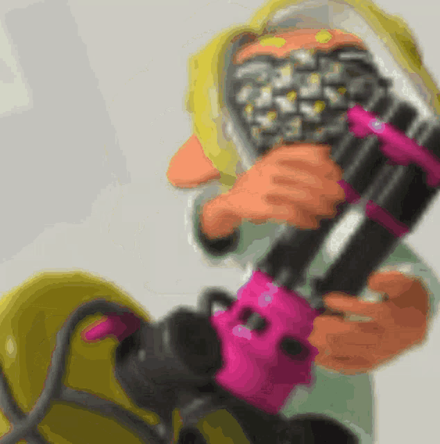 a cartoon character holding a pink and black object