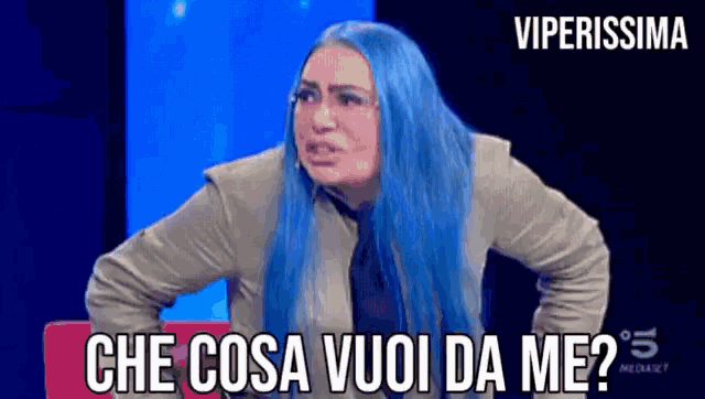 a woman with blue hair has the words che cosa vuoi da me