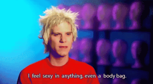 a man with blonde hair and a red shirt is saying i feel sexy in anything even a body bag