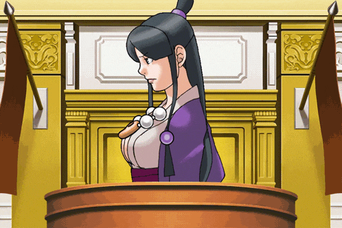 a woman in a purple dress is standing at a podium in a courtroom
