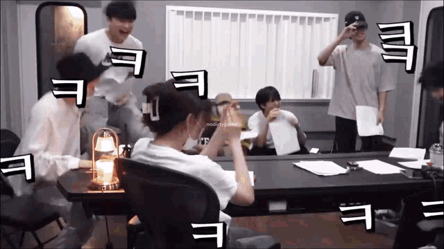 a group of people are sitting around a table with a lantern on it and one of them is wearing a mask