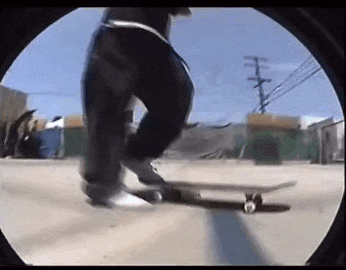 a person is riding a skateboard down a street in a city .