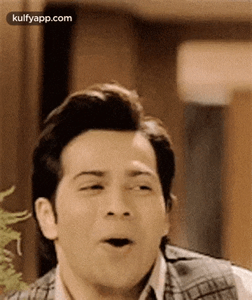 a man is making a surprised face with his mouth open .