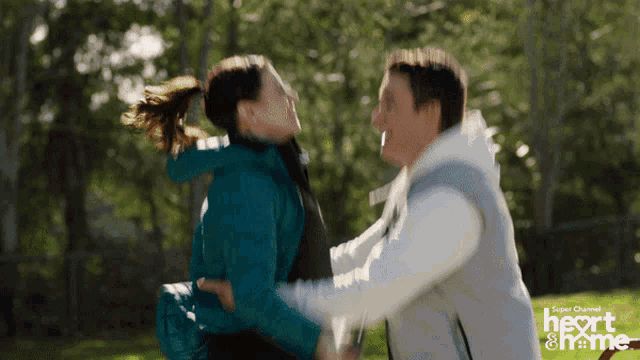 a man and a woman are hugging in a super channel heart & me ad