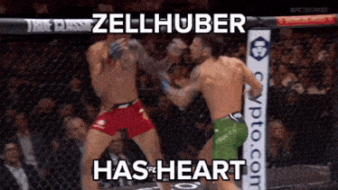 two men are fighting in a boxing ring and one of them has the word heart on his shorts