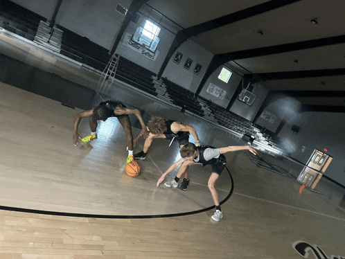 a basketball court with a few players and a sign that says ' a ' on it