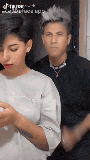 a man and a woman are standing next to each other in a tiktok video .