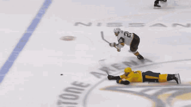 a hockey game is being played on a rink with advertisements for bridgestone and xfinity