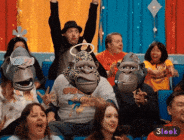 a group of people wearing gorilla masks and 3d glasses are sitting in a theater