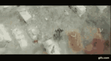 a person is standing in a pool of water with ice cubes in it .