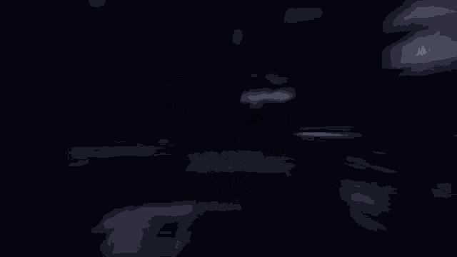 a person is standing in a dark room with a light coming from the ceiling .