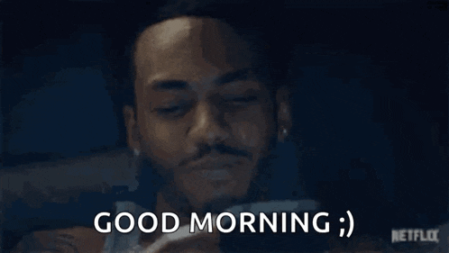a man is holding his hand to his face and saying `` good morning '' .
