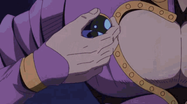 a person in a purple shirt is holding a small object in their hand