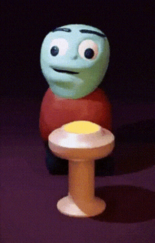 a cartoon character is standing next to a table