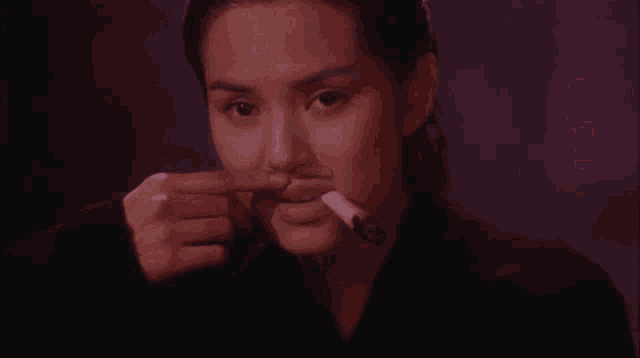 a woman with a fake mustache is smoking a cigar