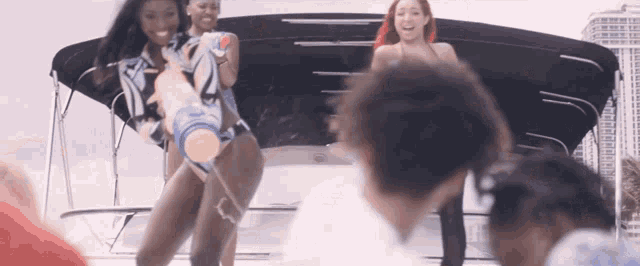 a woman in a bathing suit is holding a large water gun