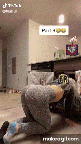 a woman crawling under a table with a sticker that says ' fr ' on it